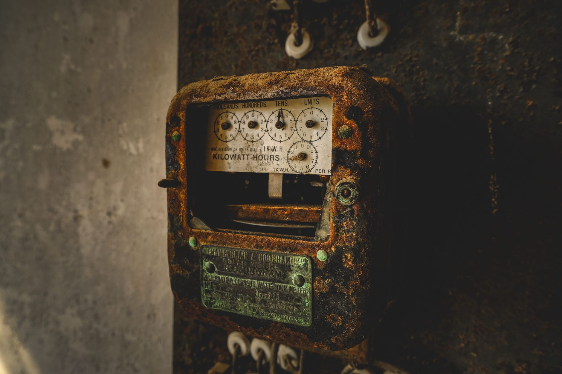 An old, rust-covered kilowatt-hour meter showcasing vintage industrial technology and nostalgia.