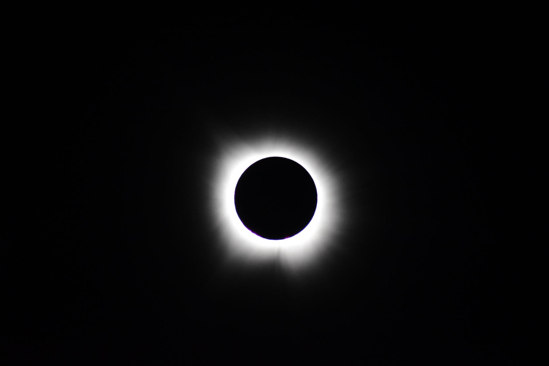 Stunning image of total solar eclipse showing the sun's corona against a dark sky.