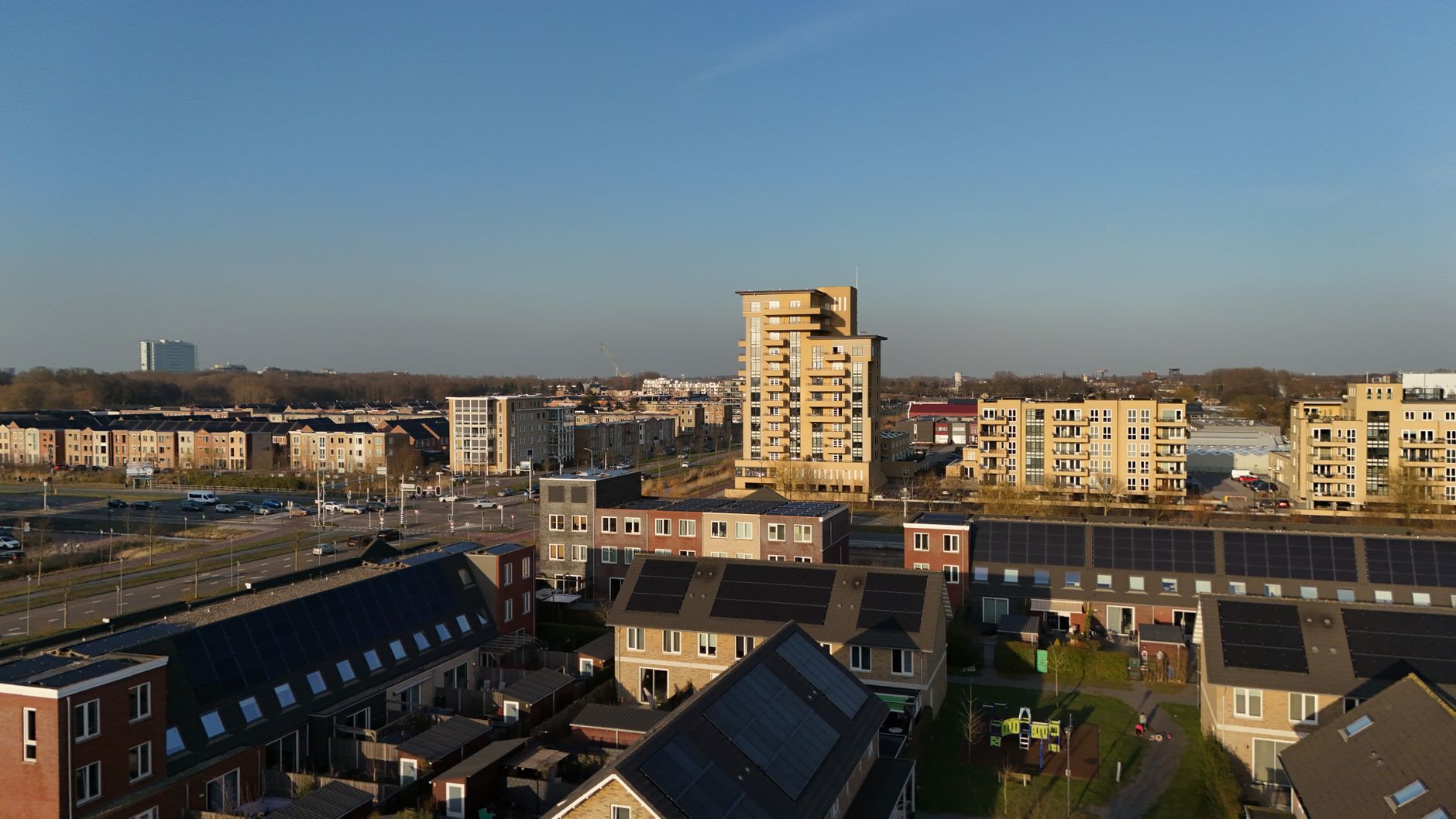 Drone capture of a modern residential area in Nederland showcasing apartment buildings and solar rooftops.