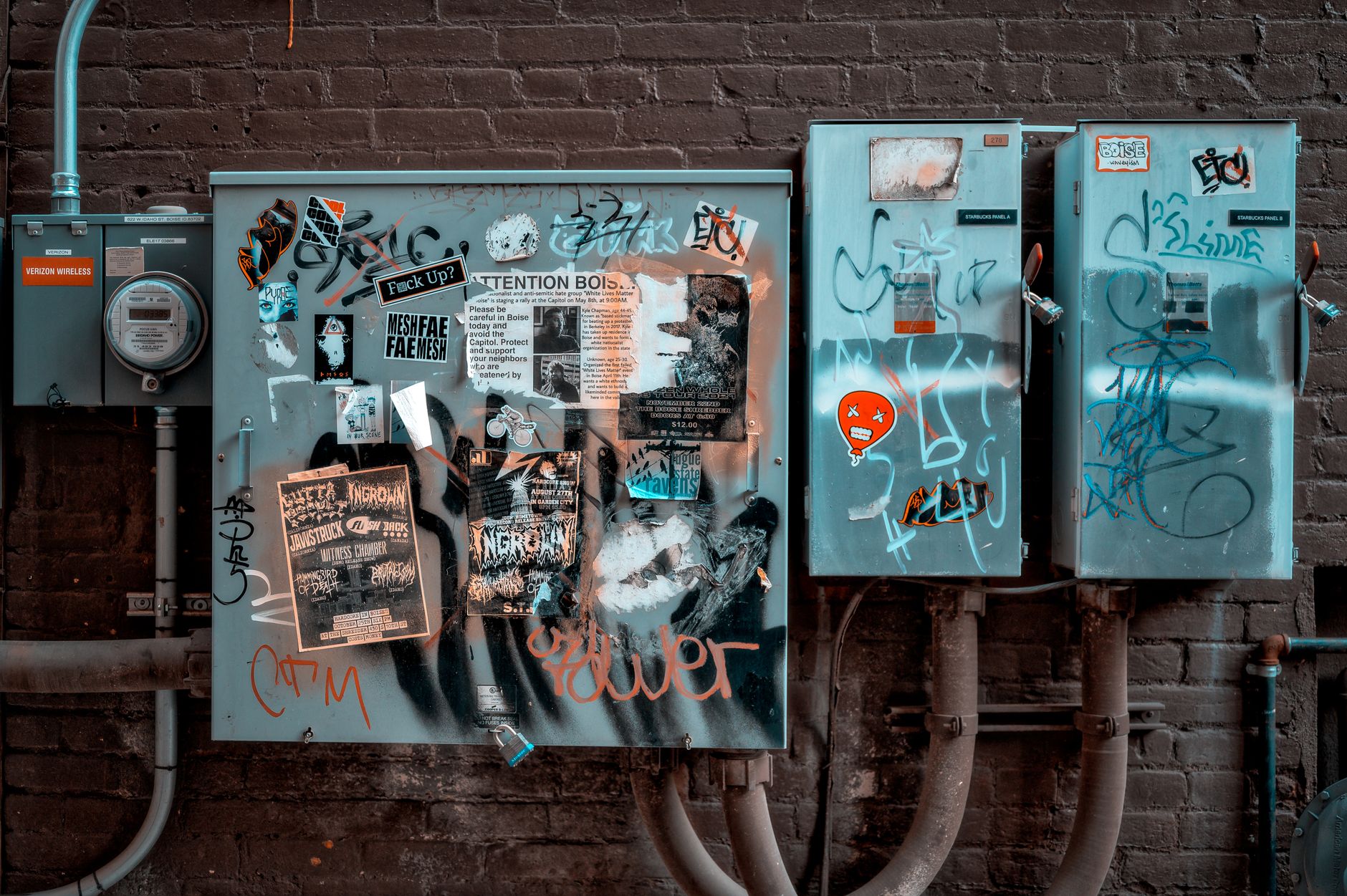 Urban street art on electrical boxes showcasing vibrant graffiti and targeted vandalism.