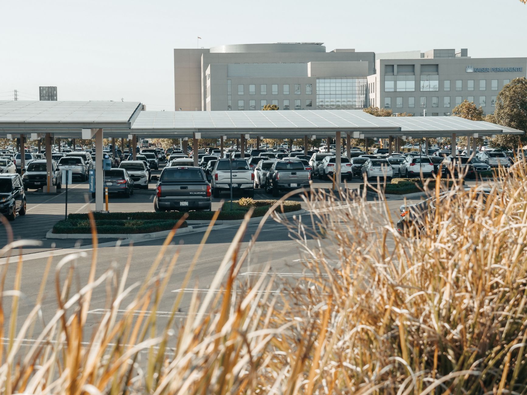 Urban parking lot with solar panel canopies providing shade and renewable energy.